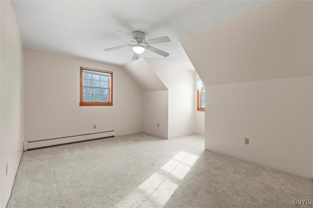 bonus room with baseboard heating, ceiling fan, vaulted ceiling, and light carpet