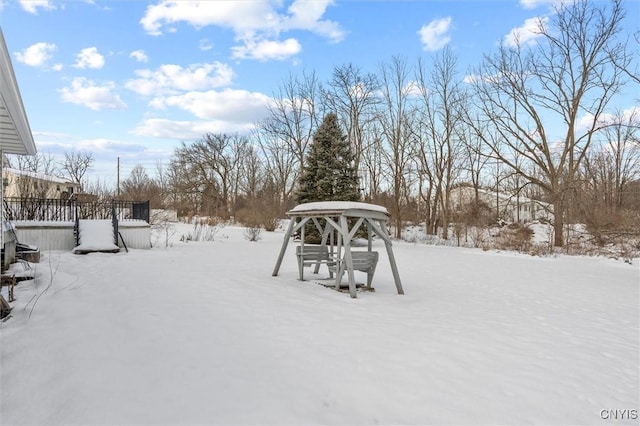 snowy yard featuring a gazebo