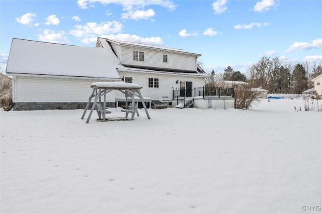 view of snow covered rear of property