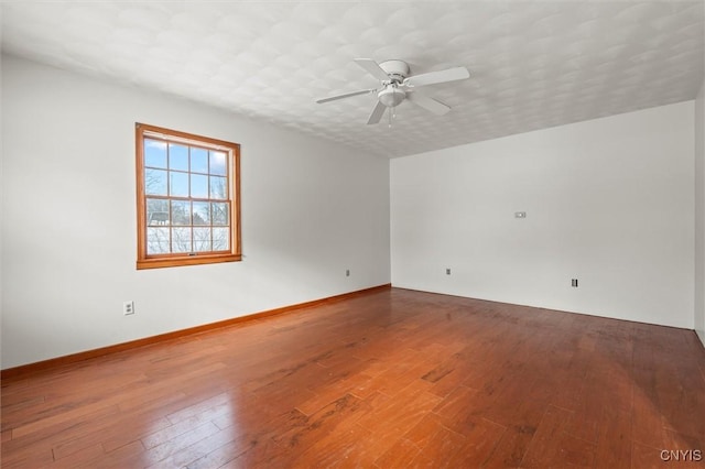 empty room featuring hardwood / wood-style flooring and ceiling fan