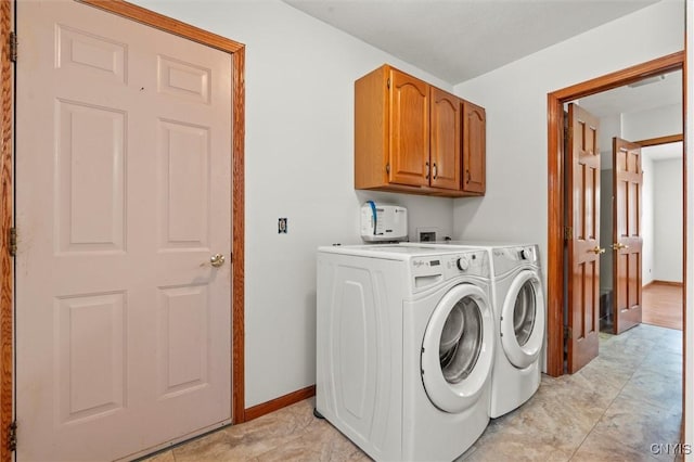 laundry area featuring washing machine and dryer and cabinets