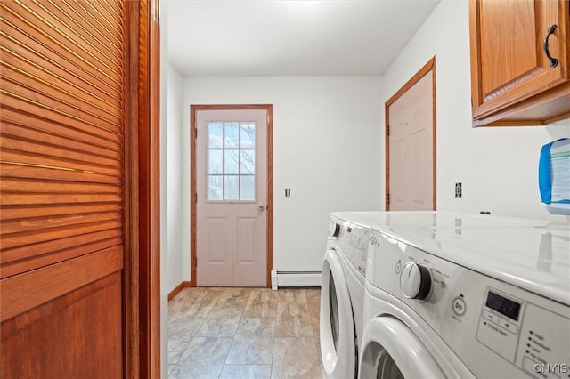 clothes washing area featuring cabinets, a baseboard radiator, and independent washer and dryer