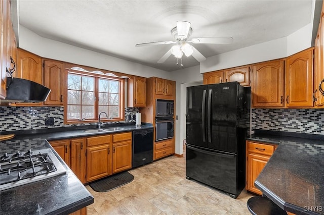 kitchen featuring tasteful backsplash, sink, black appliances, and range hood