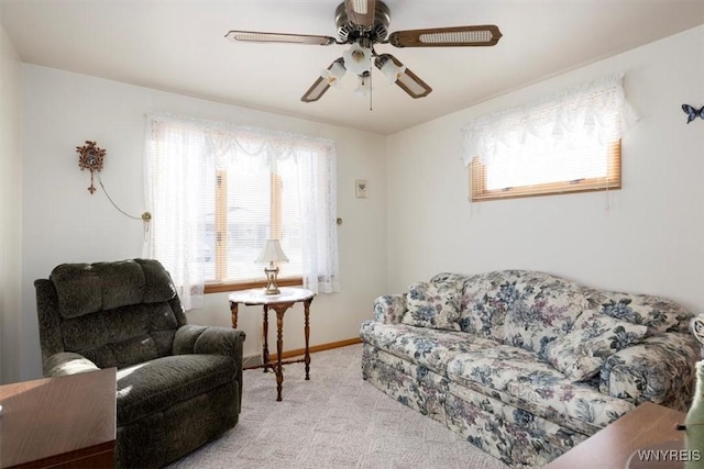 carpeted living room featuring ceiling fan