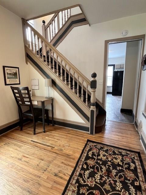 stairs featuring hardwood / wood-style flooring