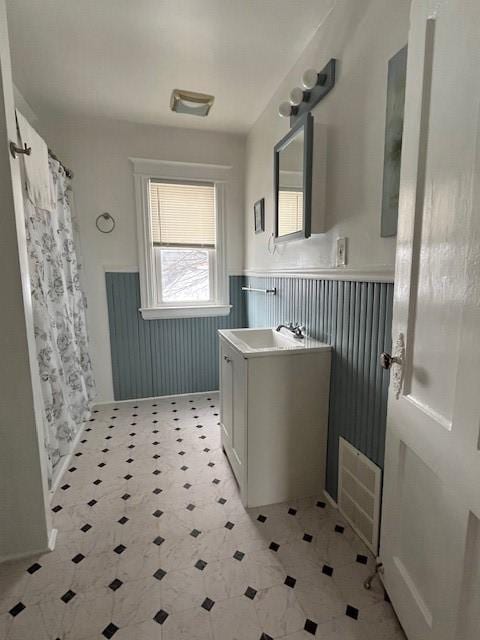 bathroom featuring vanity and curtained shower