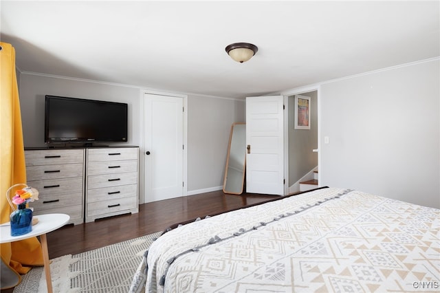 bedroom with dark hardwood / wood-style flooring