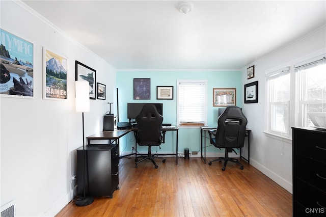 office area with ornamental molding, plenty of natural light, and hardwood / wood-style floors