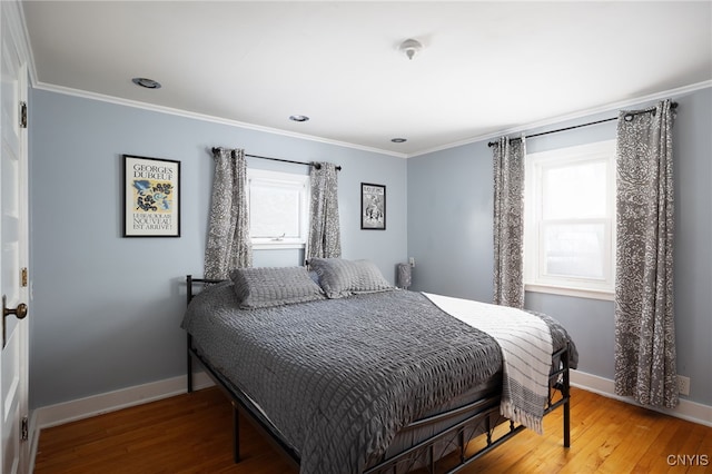 bedroom featuring hardwood / wood-style flooring and crown molding