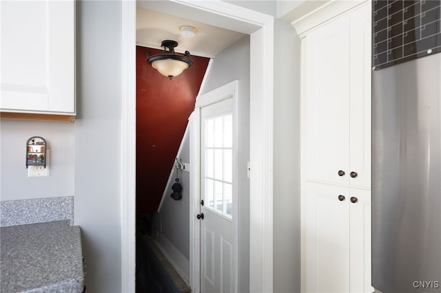 doorway featuring lofted ceiling