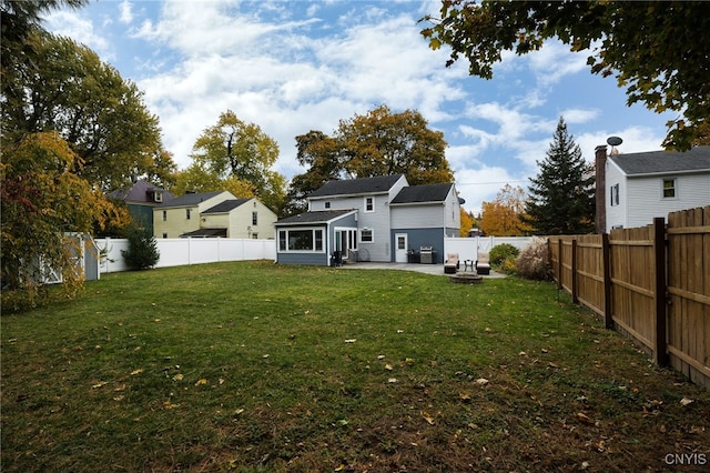 rear view of house with a yard and a patio