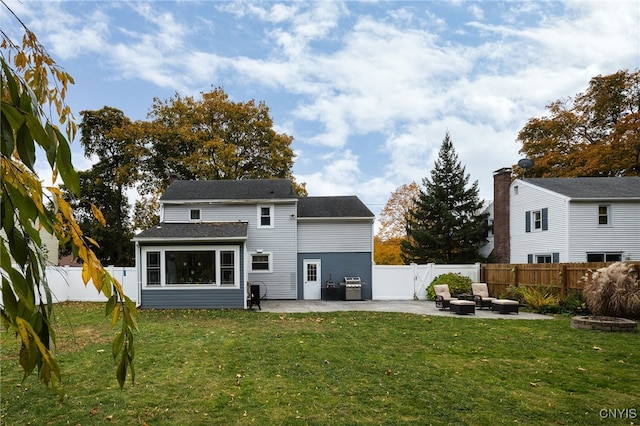 back of house featuring an outdoor living space, a lawn, and a patio