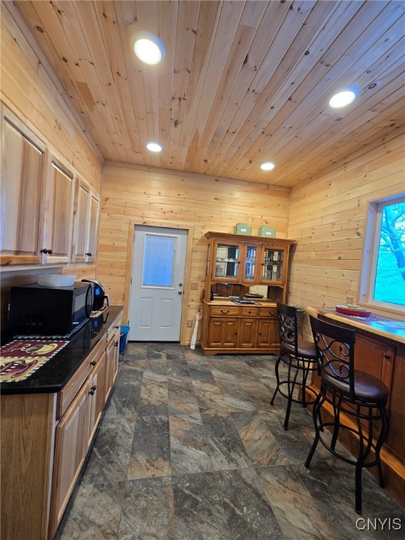 kitchen with wooden ceiling and wood walls