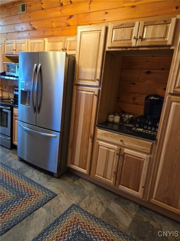 kitchen with wooden walls and stainless steel appliances