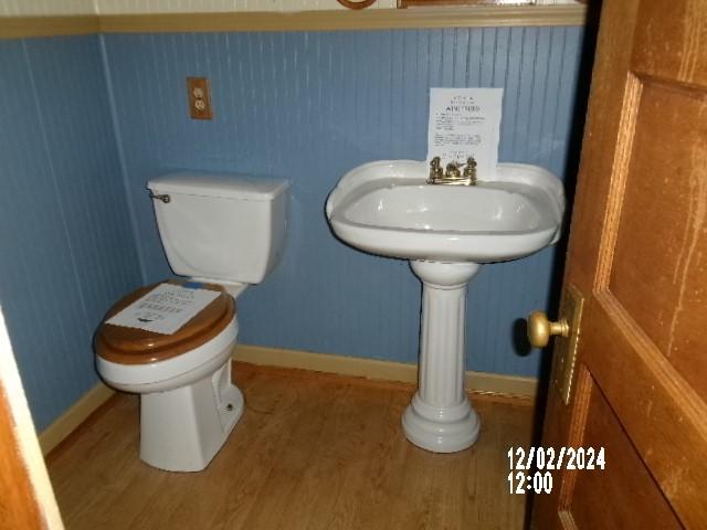 bathroom featuring hardwood / wood-style floors and toilet