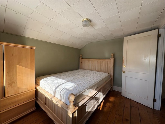 bedroom featuring dark hardwood / wood-style floors and vaulted ceiling