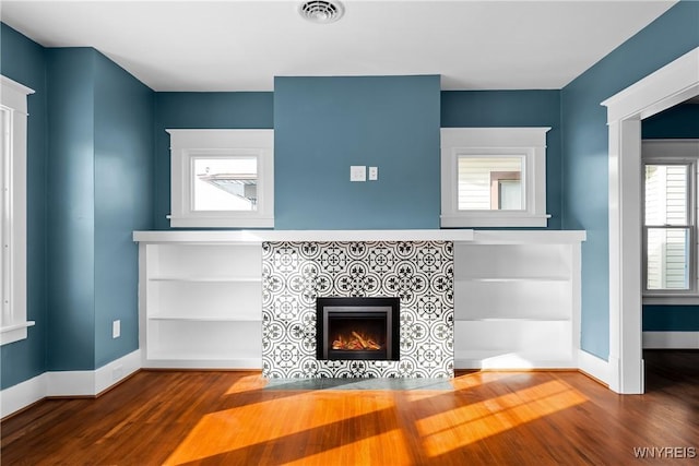 unfurnished living room featuring hardwood / wood-style floors and a fireplace