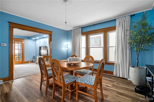 dining space featuring dark hardwood / wood-style flooring and a healthy amount of sunlight