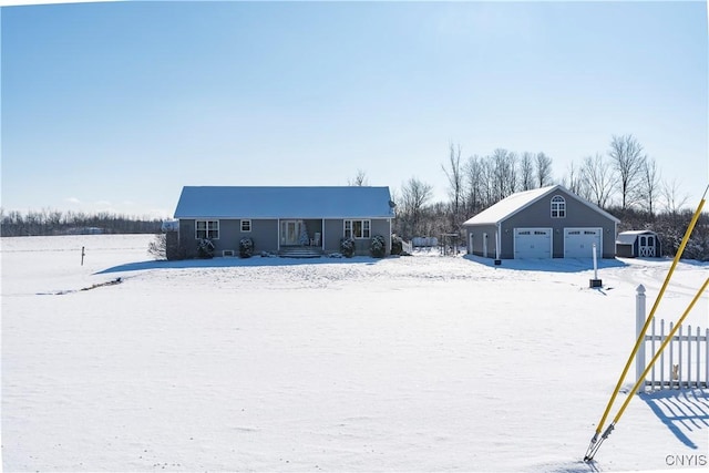 view of front of property featuring a garage and an outdoor structure