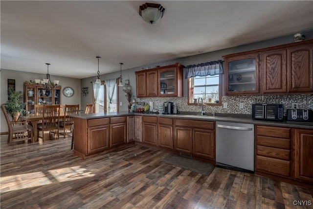 kitchen with sink, decorative light fixtures, dark hardwood / wood-style flooring, dishwasher, and kitchen peninsula