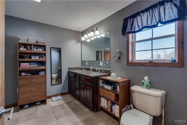 bathroom featuring vanity, backsplash, tile patterned floors, and toilet