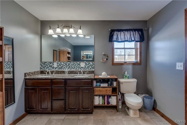 bathroom with vanity, backsplash, tile patterned flooring, and toilet