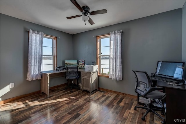 home office with dark hardwood / wood-style flooring and ceiling fan