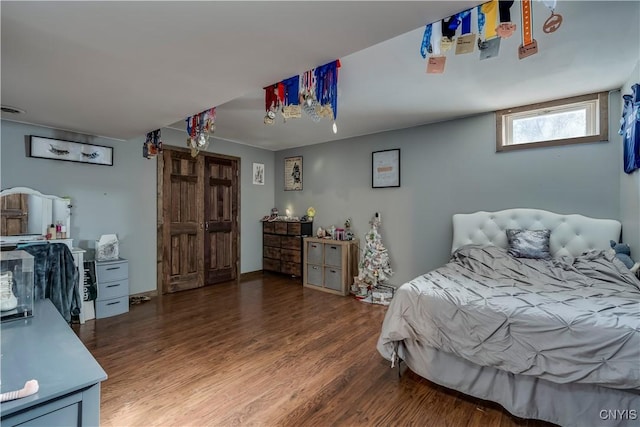 bedroom with dark wood-type flooring