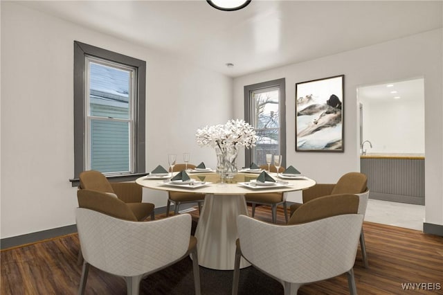 dining area with dark hardwood / wood-style floors