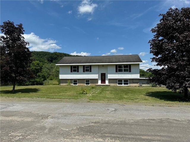 bi-level home with a front lawn