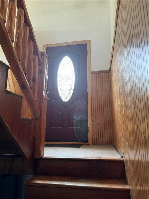 foyer entrance with wood walls