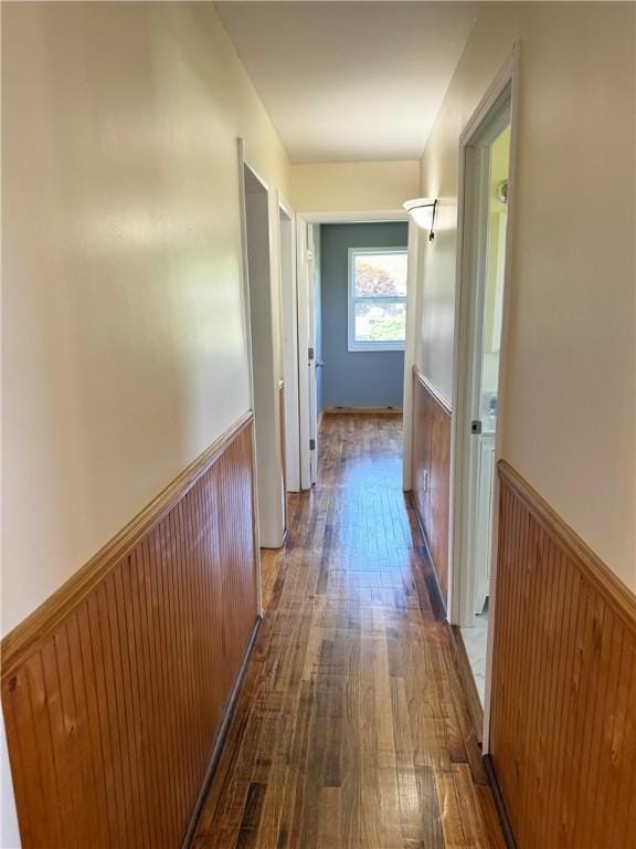 hallway with dark hardwood / wood-style floors