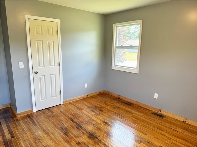 spare room with hardwood / wood-style flooring