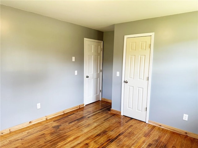 unfurnished bedroom featuring hardwood / wood-style flooring and a closet