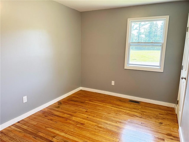 spare room with light hardwood / wood-style floors