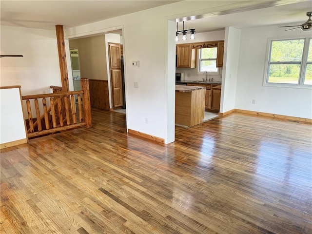 110 Suncrest Terrace Rd, Norwich-Town, NY 13815 - unfurnished living room featuring ceiling fan, light wood-type flooring, baseboards, and a sink