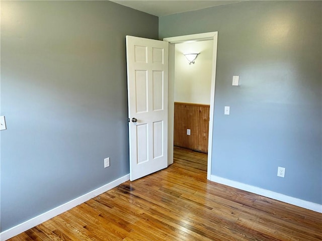 110 Suncrest Terrace Rd, Norwich-Town, NY 13815 - unfurnished room with wood finished floors, baseboards, and a wainscoted wall