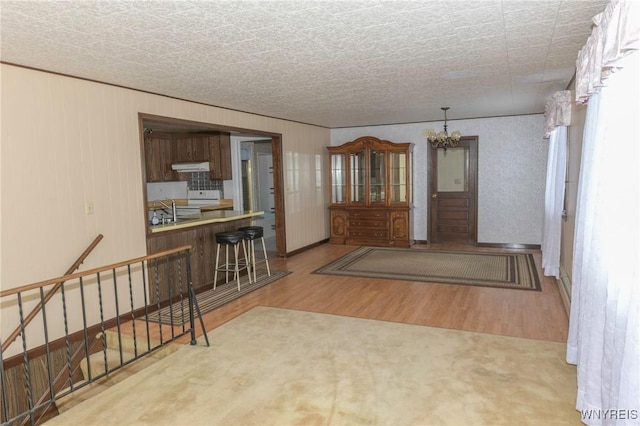 interior space with sink, hardwood / wood-style floors, and a notable chandelier