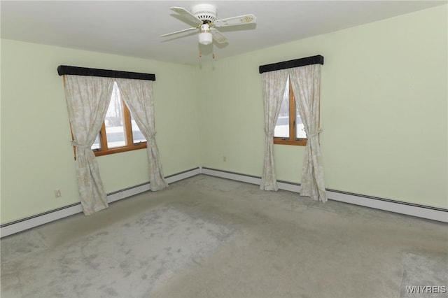 unfurnished room featuring ceiling fan and baseboard heating