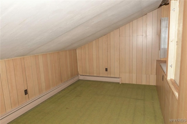 bonus room featuring lofted ceiling, wooden walls, and dark colored carpet