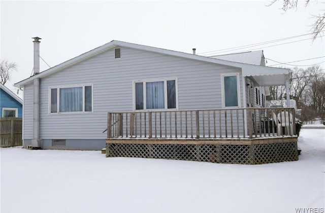 view of snow covered rear of property