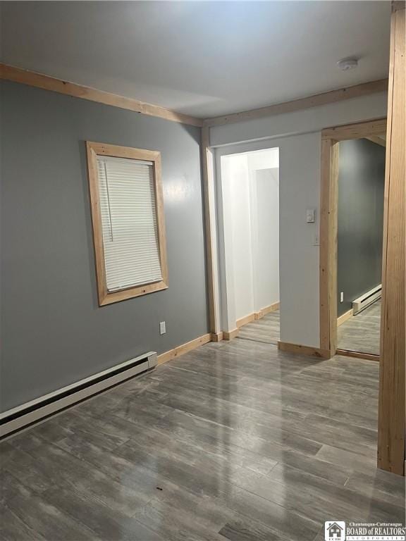 unfurnished room featuring a baseboard radiator and wood-type flooring