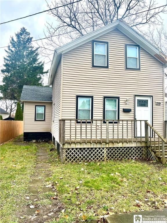 rear view of house featuring a yard