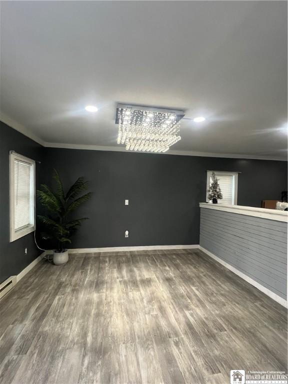 unfurnished room featuring crown molding and hardwood / wood-style floors