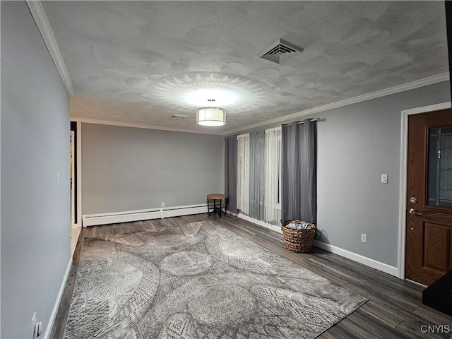 spare room featuring ornamental molding, a baseboard heating unit, and dark wood-type flooring