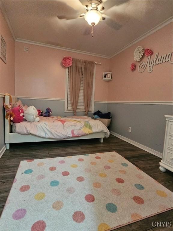 bedroom featuring dark wood-type flooring, ceiling fan, and ornamental molding