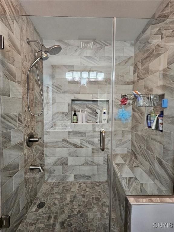 bathroom featuring a shower with shower door