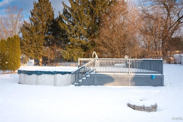 snow covered pool with a deck