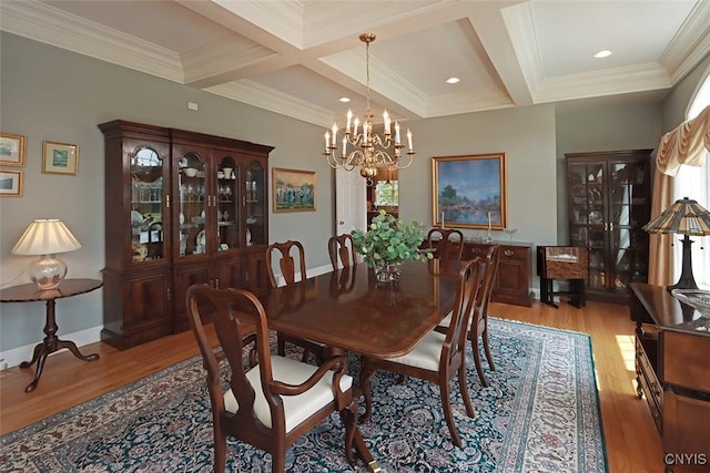 dining space featuring beamed ceiling, ornamental molding, coffered ceiling, light hardwood / wood-style floors, and an inviting chandelier