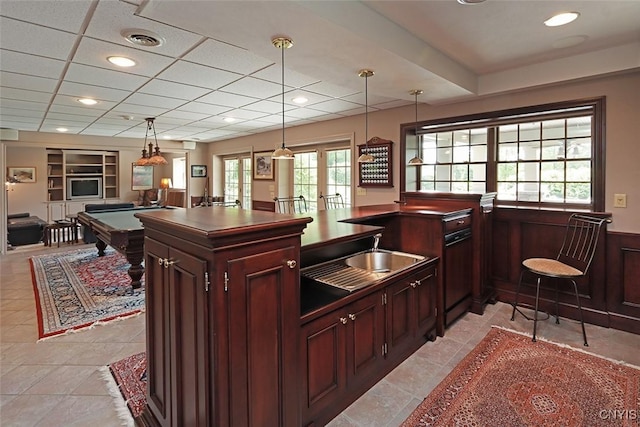 bar featuring french doors, sink, pool table, built in features, and pendant lighting